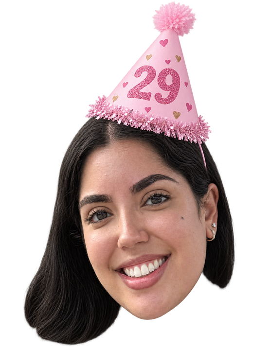 Klarissa smiling in a pink glitter party hat with the number 29 on it